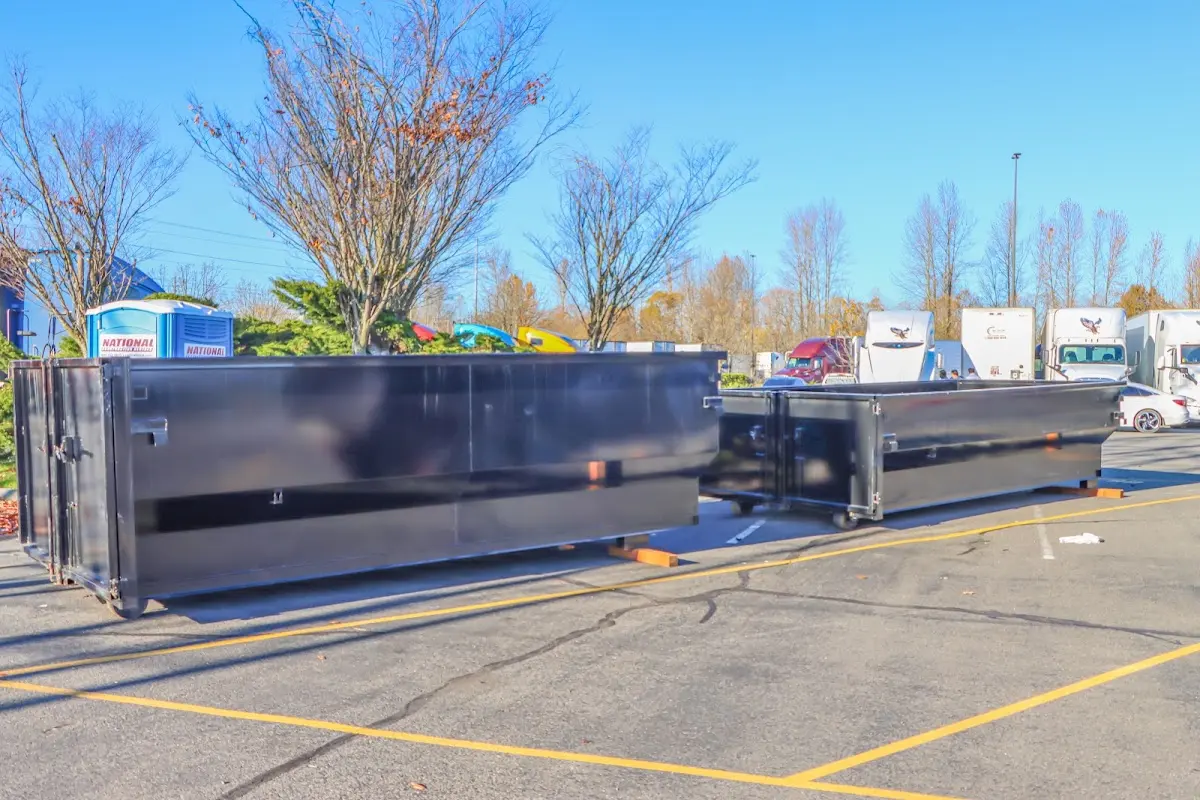 Professional dumpster rental service with roll-off container on residential driveway in O'Fallon